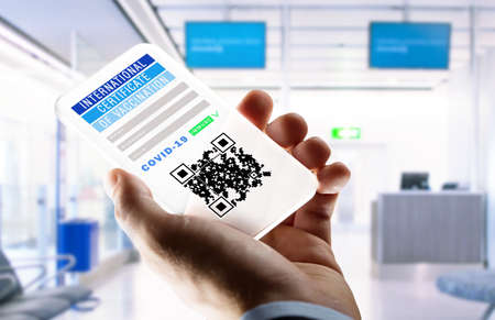 hand holding phone with certificate of vaccination