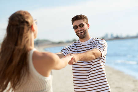 happy couple hugging on summer beachの写真素材