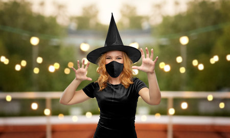 woman in black mask and halloween costume of witchの写真素材