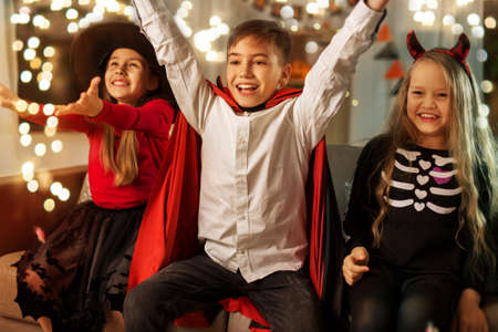 kids in halloween costumes s having fun at homeの写真素材