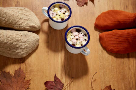 couple of feet in socks, coffee and autumn leaves