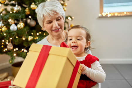 grandmother and baby girl with christmas gift