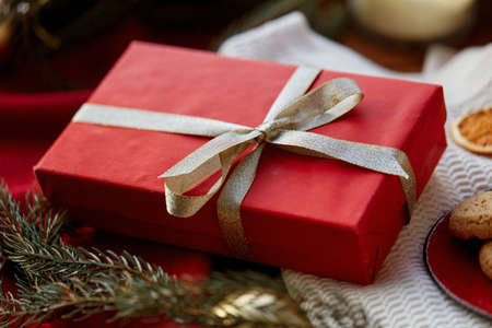 christmas gift in red wrapping with golden bowの写真素材