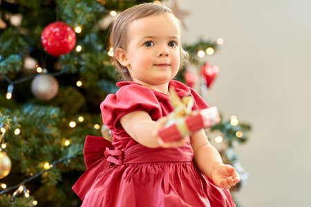 happy baby girl with christmas gift at home