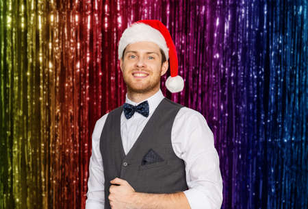 happy man in santa hat and suit on christmasの写真素材