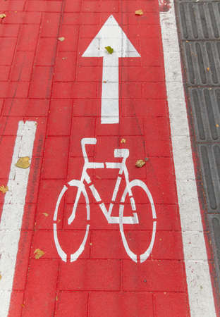 bike lane or red road with signs of bicyclesの写真素材
