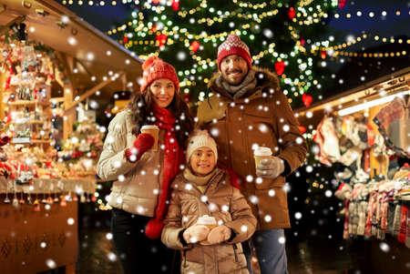 family with takeaway drinks at christmas marketの写真素材