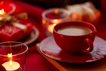 cup of coffee and candles at home on christmasの写真素材