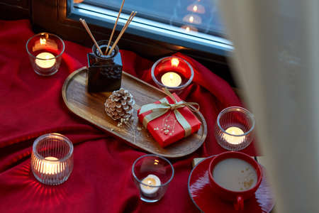 christmas gift, candles and coffee on window sillの写真素材