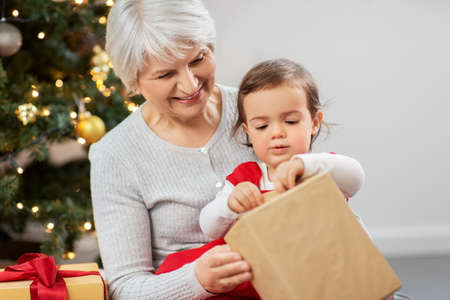 grandmother and baby girl with christmas giftsの写真素材