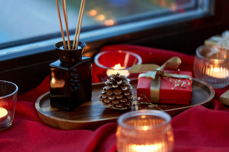 christmas gift, candles, reed diffuser on windowの写真素材