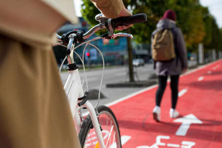 close up of cyclist behind pedestrian on bike laneの写真素材