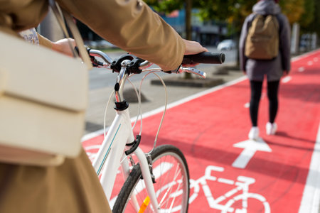 close up of cyclist behind pedestrian on bike laneの写真素材