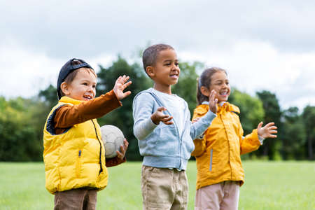 happy children with soccer ball at park