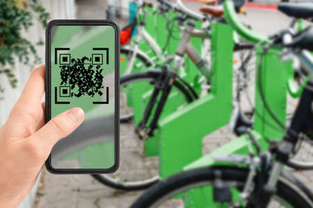 qr code on phone at electric bike charging station