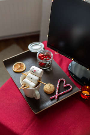 marshmallow snowman in cup of coffee on christmasの写真素材