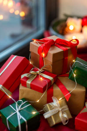 christmas gifts on red tablecloth on window sillの写真素材