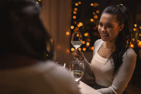 happy woman drinking wine at christmas dinner