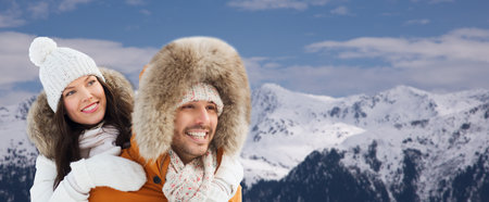 happy couple having fun over winter and mountainsの写真素材