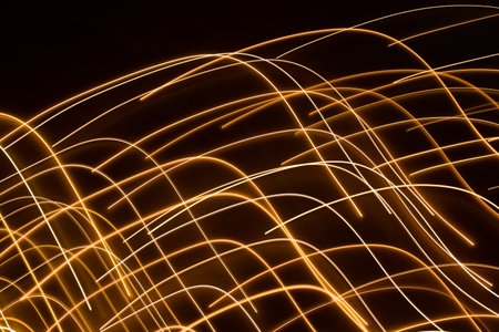 golden electric light effect on dark backgroundの写真素材