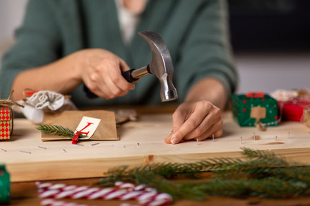 woman making advent calendar on christmas at homeの写真素材
