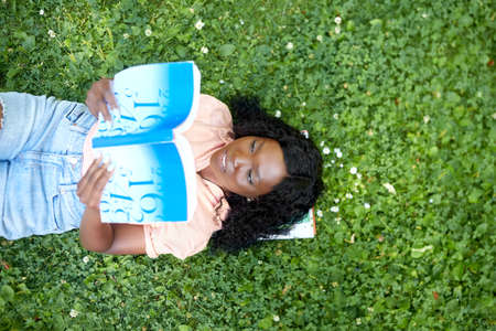 african student girl reading math textbook