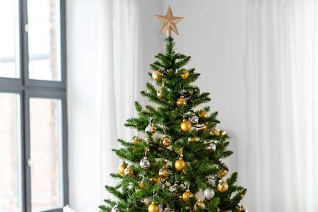 decorated artificial christmas tree at homeの写真素材