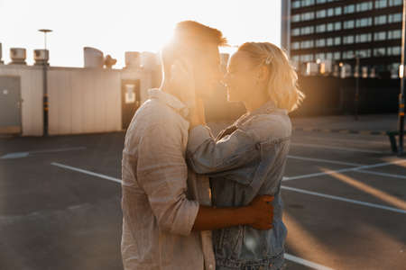 happy young couple on roof top city parkingの写真素材