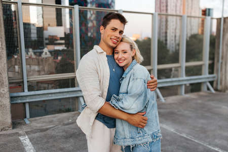 happy couple hugging on roof top city parking