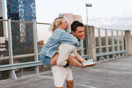 happy young couple having fun on roof top parkingの写真素材