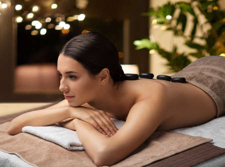 woman having hot stone massage at spaの写真素材