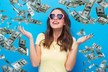 teenage girl in heart-shaped sunglasses over money