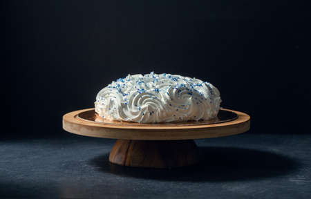close up of zephyr cake on wooden stand