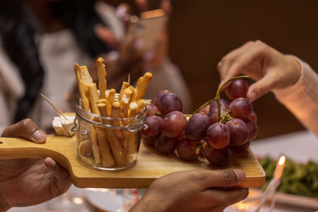close up of people share food at dinner partyの写真素材