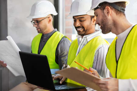 male architects in helmets working at officeの写真素材