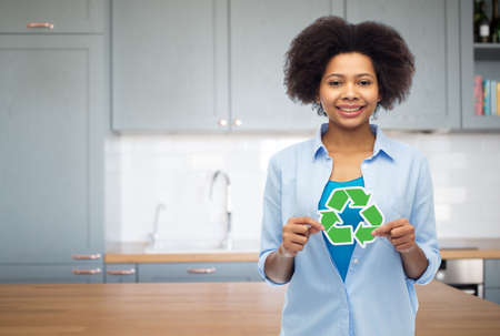 happy young woman with recycling sign on kitchenの写真素材