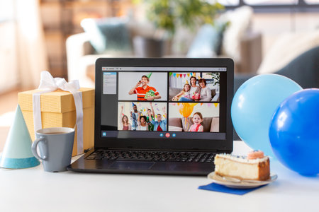 laptop with video call or online birthday partyの写真素材