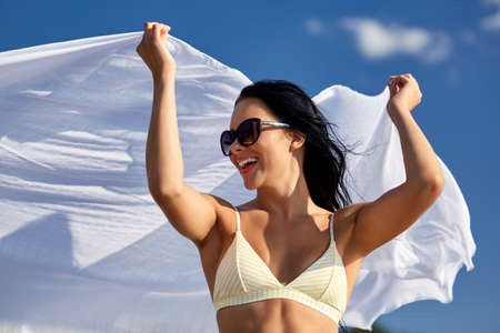 woman in bikini swimsuit with cover-up over skyの写真素材