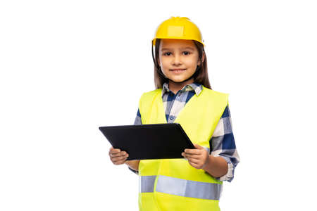 girl in helmet and safety vest with tablet pcの写真素材