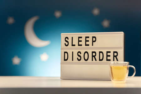 light box with sleep disorder words and cup of teaの写真素材
