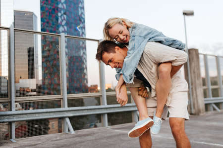 happy young couple having fun on roof top parkingの写真素材