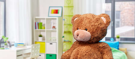 teddy bear toy over childrens room backgroundの写真素材