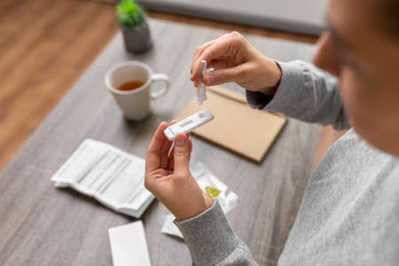 woman making self testing virus test at home