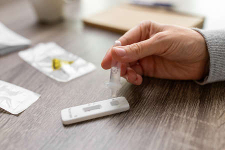 woman making self testing virus test at home