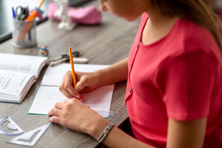 student with ruler and pencil drawing in notebookの写真素材