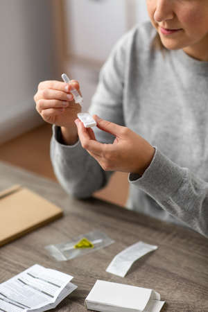 woman making self testing coronavirus test at home