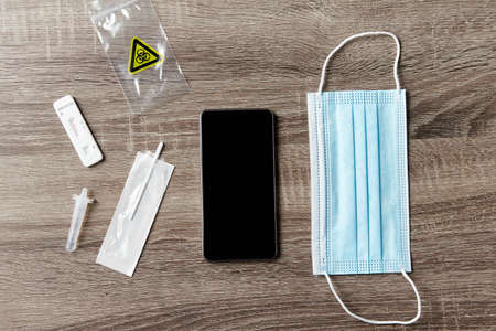 coronavirus self testing kit, smartphone and maskの写真素材