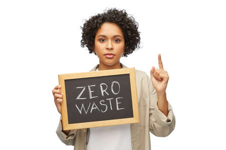 woman with zero waste words on chalkboard