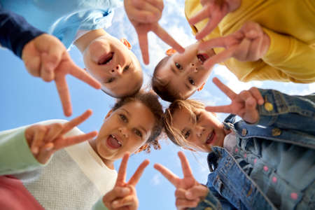 group of happy children showing peace gestureの写真素材