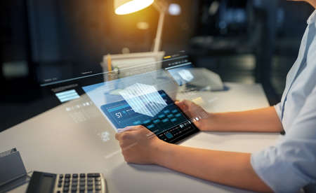 businesswoman with tablet computer at night office